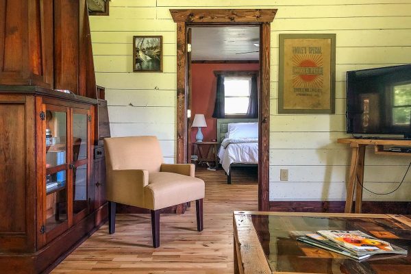 Living room and entry to bedroom 1 — Piney River Farmhouse